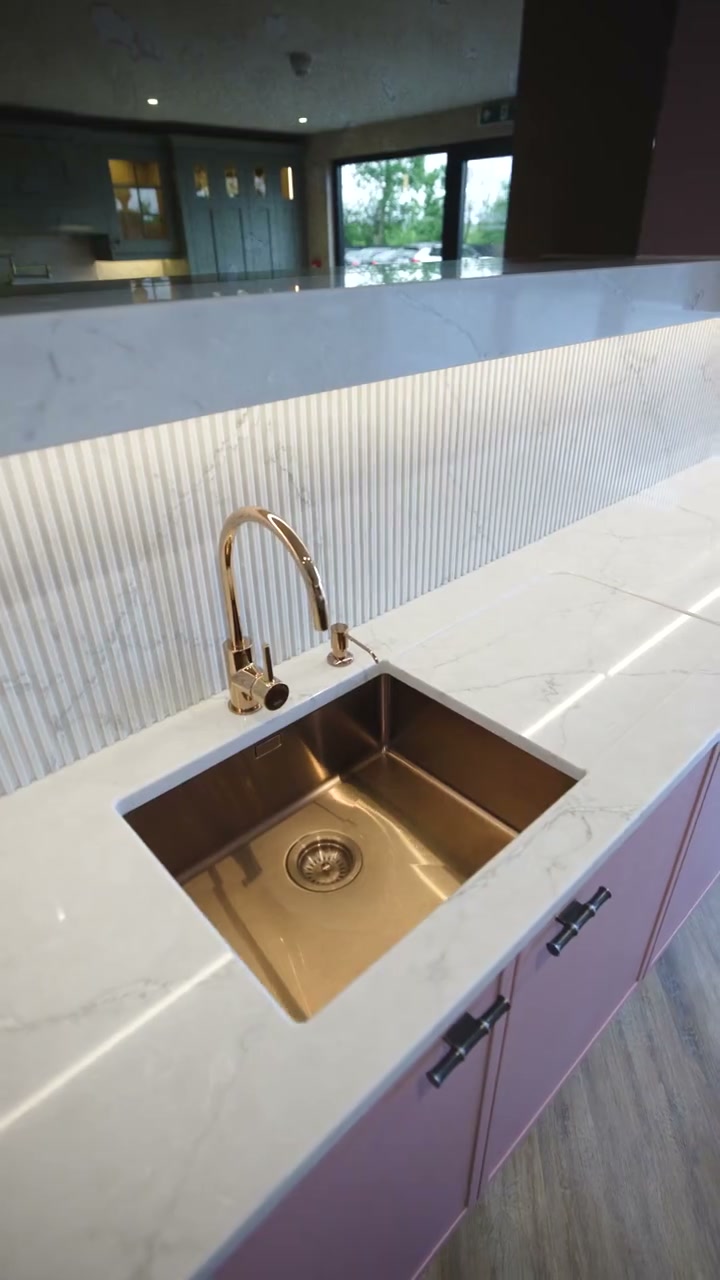 A copper undermount sink in a CEK marble worktop